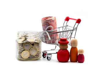 5,000 Kazakhstani tenge banknotes and a glass jar with 100 tenge coins on a white background