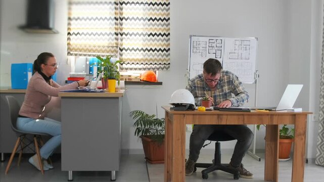 professional architect creates detailed plans using multiple tools and technology, an architect at work actively sketches detailed building plans utilizing both traditional and digital drafting tools