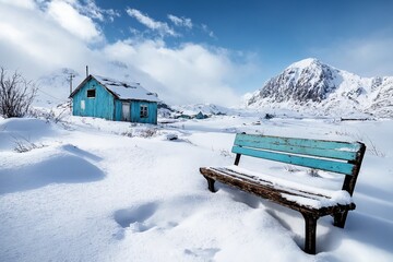 Abandoned snowy village with wooden bench and blue house in winter mountains
