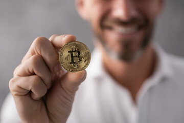 Successful man secures his investment holding a physical Bitcoin crypto asset