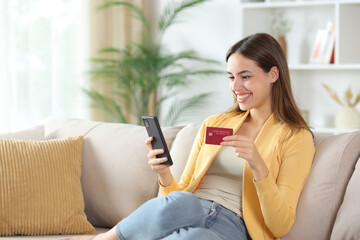 Happy woman in yellow buying online at home