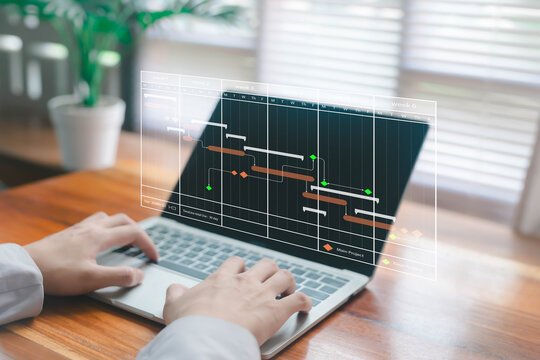 A digital project management concept showing a Gantt chart interface displayed above a laptop as hands work on tasks, illustrating scheduling, workflow planning, productivity, professional business