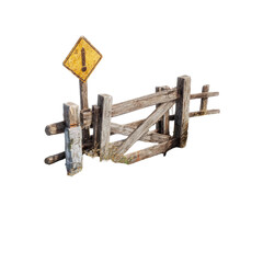 Obraz premium Weathered wooden gate with a yellow warning sign, isolated against a black background