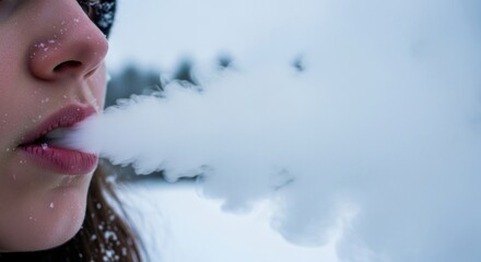 A woman exhaling smoke from her mouth against a snowy background.
