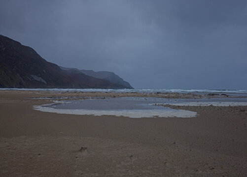 Stormy Scene of Maghera Beach Donegal Ireland with tide pools and seaweed