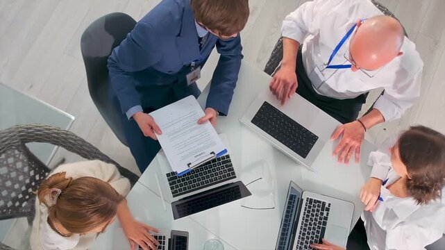 legal professionals collaboratively analyze agreements and associated materials extensively, team of specialists is meticulously reviewing legal contracts and ensuring full compliance with guidelines