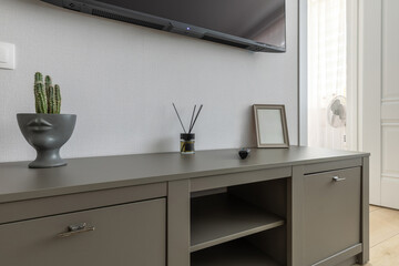 Modern TV Stand with Decorative Accessories in Bright Interior