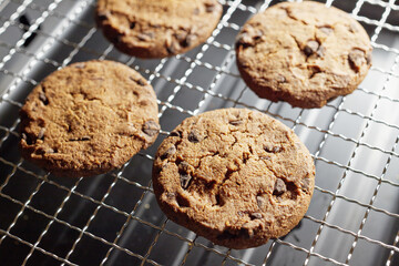 Sweet chocolate chip cookies on a metal grill grate