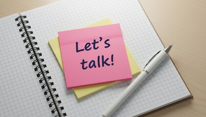 Let's Talk message on pink sticky note on spiral notebook with pen, symbolizing open communication