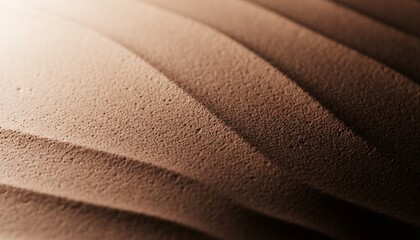 Abstract textured background with wavy patterns, soft lighting, and granular surface detail in warm brown tones.