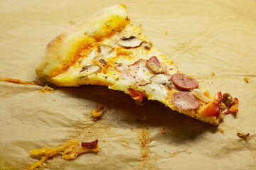 Last slice of pizza inside a pizza box