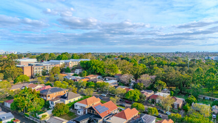 Obraz premium Aerial Panorama Drone View of a inner western Sydney Suburb of Ashbury Urban Sprawl and the terracotta roof tops streets and trees of Suburban Sydney NSW Australia