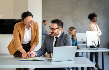 Business men with colleague traders at office monitoring stocks data on screen analyzing price flow