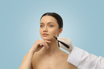 A beautician prepares a client for a facial procedure with markings