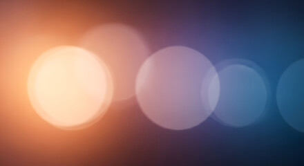 Soft and dreamy bokeh effect with warm orange and cool blue hues creating a serene and visually appealing abstract background