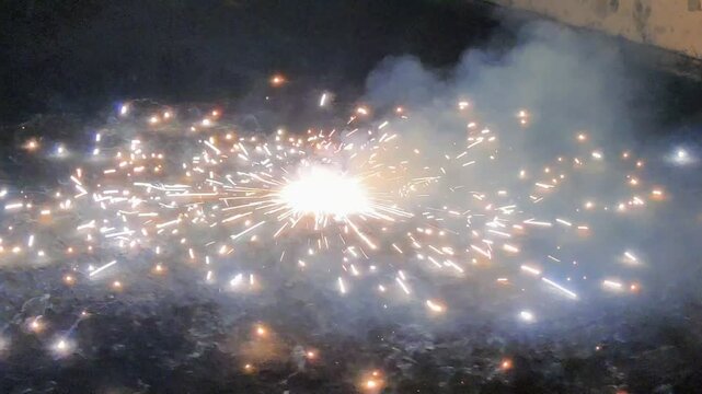Footage of fireworks shot in the night sky as background. Close-up shot of fire crackers during festival of Diwali in India
