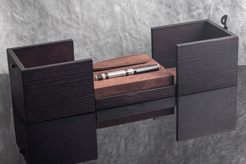 Fountain pen on a gray marble background. Boxed and unboxed. Selective focus.