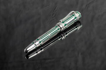 Fountain pen on a gray marble background. Boxed and unboxed. Selective focus.