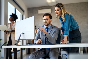 Group of multi-ethnic corporate business team collaborating on project in modern office