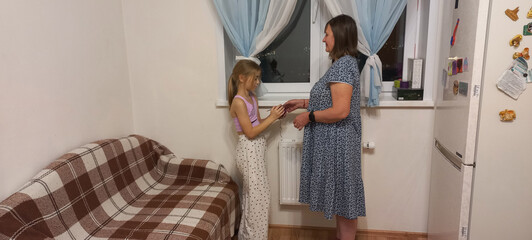 Mother and daughter interacting in a cozy living room at home  