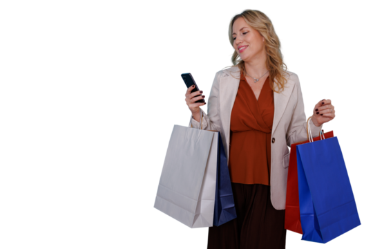 Happy woman holding shopping bags and using smartphone, smiling while shopping online or texting, transparent background