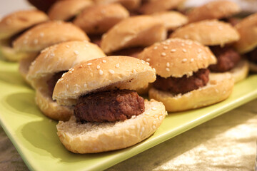 Tray of mini beef burgers in sesame buns
