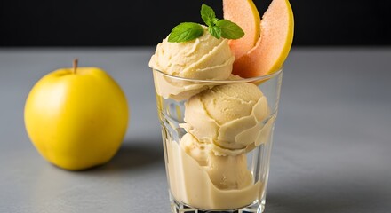 A refreshing apple sorbet served in a tall glass, garnished with a slice of quince for a fruity, elegant dessert