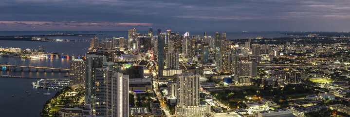 Aerial view of the vibrant cityscape, with its glittering lights reflecting on the water near the bridge, Edgewater, Miami, United States.