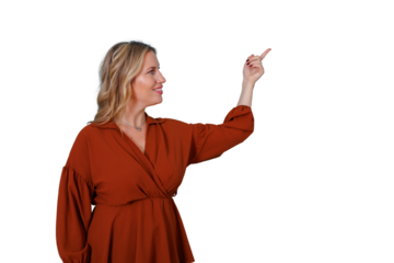 Smiling woman pointing finger upwards and looking sideways to the right, showing and presenting information on transparent background