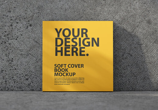 Square Soft cover book mockup with shadows from plant