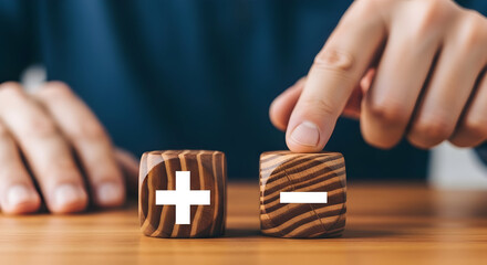 Choose plus or minus for your business with these wooden blocks and hand