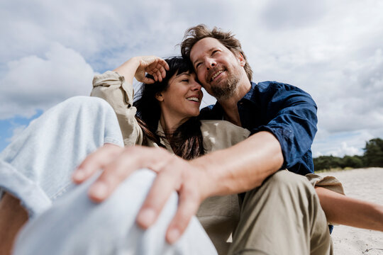 Couple embracing outdoors on a windy day showing love and trust