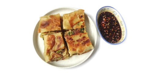 Martabak Telor with Soy Sauce Served On a Plate. Traditional Indonesian Street Food. Food Photography Presentation. Isolated on White Background