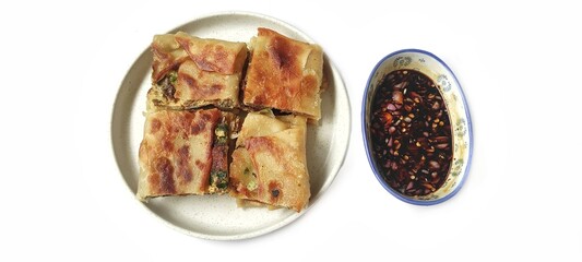Martabak Telor with Soy Sauce Served On a Plate. Traditional Indonesian Street Food. Food Photography Presentation. Isolated on White Background