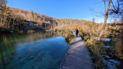 Pretty hiker woman enjoying scenic nature trail at Plitvicka Jezera national park lake landscape travel adventure outdoor Croatia