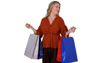 Happy woman experiencing retail therapy, smiling and looking away while holding paper shopping bags, transparent background