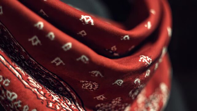 Close-up of a Red Bandana with White Paisley Pattern, Folded and Draped, Creating a Textured and Stylish Background