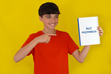 self-expression. children's mental well-being. child pointing to words in a notebook