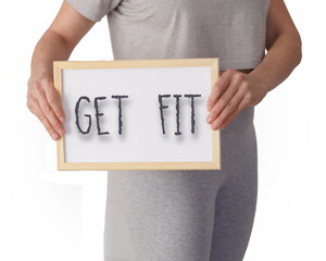Get fit. Words written on the blackboard by a woman dressed in sportswear.