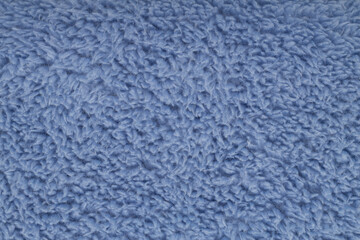 Soft blue fuzzy sherpa fleece fabric background © MAXSHOT_PL