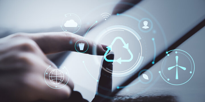 Hand interacting with digital tablet showing recycling and eco-friendly icons on light background with creative environmental technology concept. - Powered by Adobe