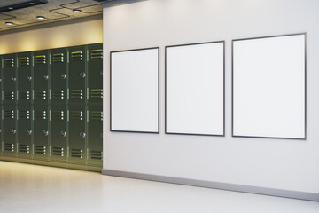 Three vertical blank poster frames on a light wall in a modern hallway interior with lockers, ideal for design presentation or branding display mockup. 3D Rendering © Who is Danny