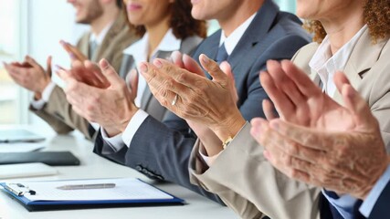 Businesspeople applauding a success or announcement during a meeting in a boardroom.