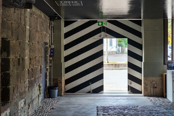 Black and white stripes old gate with open door