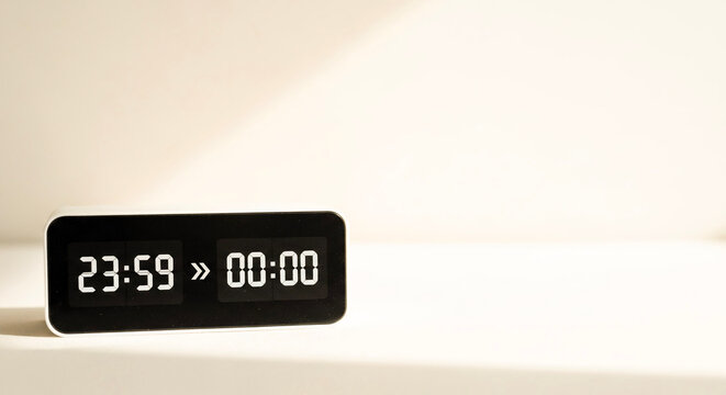Digital clock displaying time transition from 23:59 to 00:00  