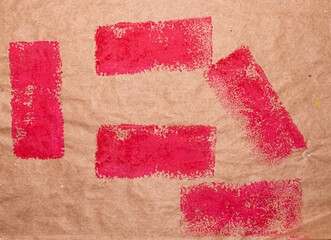 painted red rectangles on brown paper