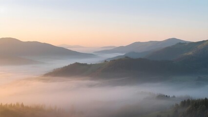 Scenic mountain landscape with fog and glowing sunrise over rolling hills