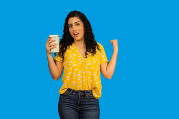 Woman feeling success and strength holding a reusable cup