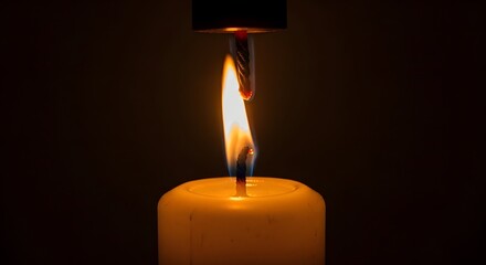 A close-up of a lit matchstick igniting a candle flame in a dark setting, highlighting the process of lighting a candle with a matchstick