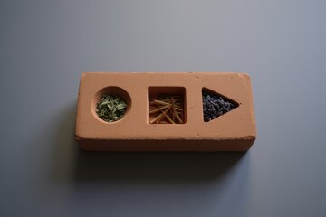 Wooden shape sorter toy with colorful beads and small objects